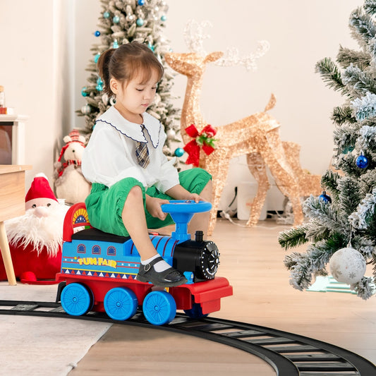 The kids electric train being ridden by a child in a festive room with Christmas decorations