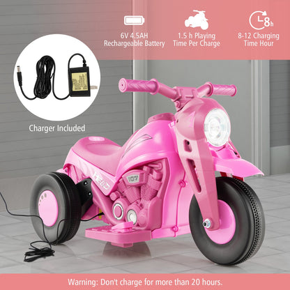 The pink electric ride on motorbike with its charger plugged in, showing charging information