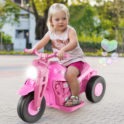 A young child happily riding the pink electric motorbike on a paved surface