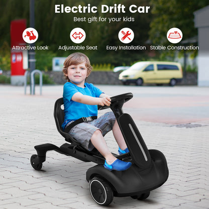 The kids electric car being driven by a young boy on a paved driveway