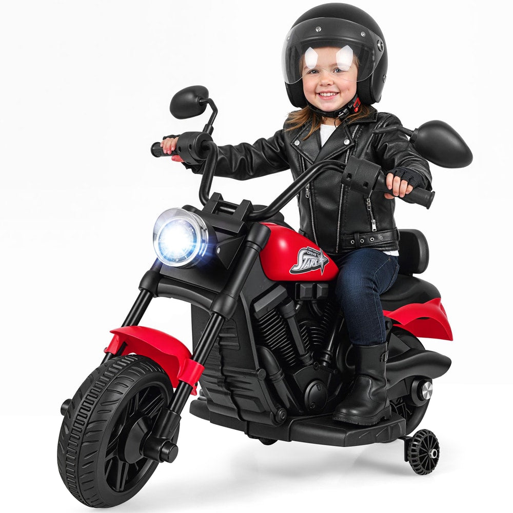 A child wearing a helmet and leather jacket rides the red kids electric motorbike