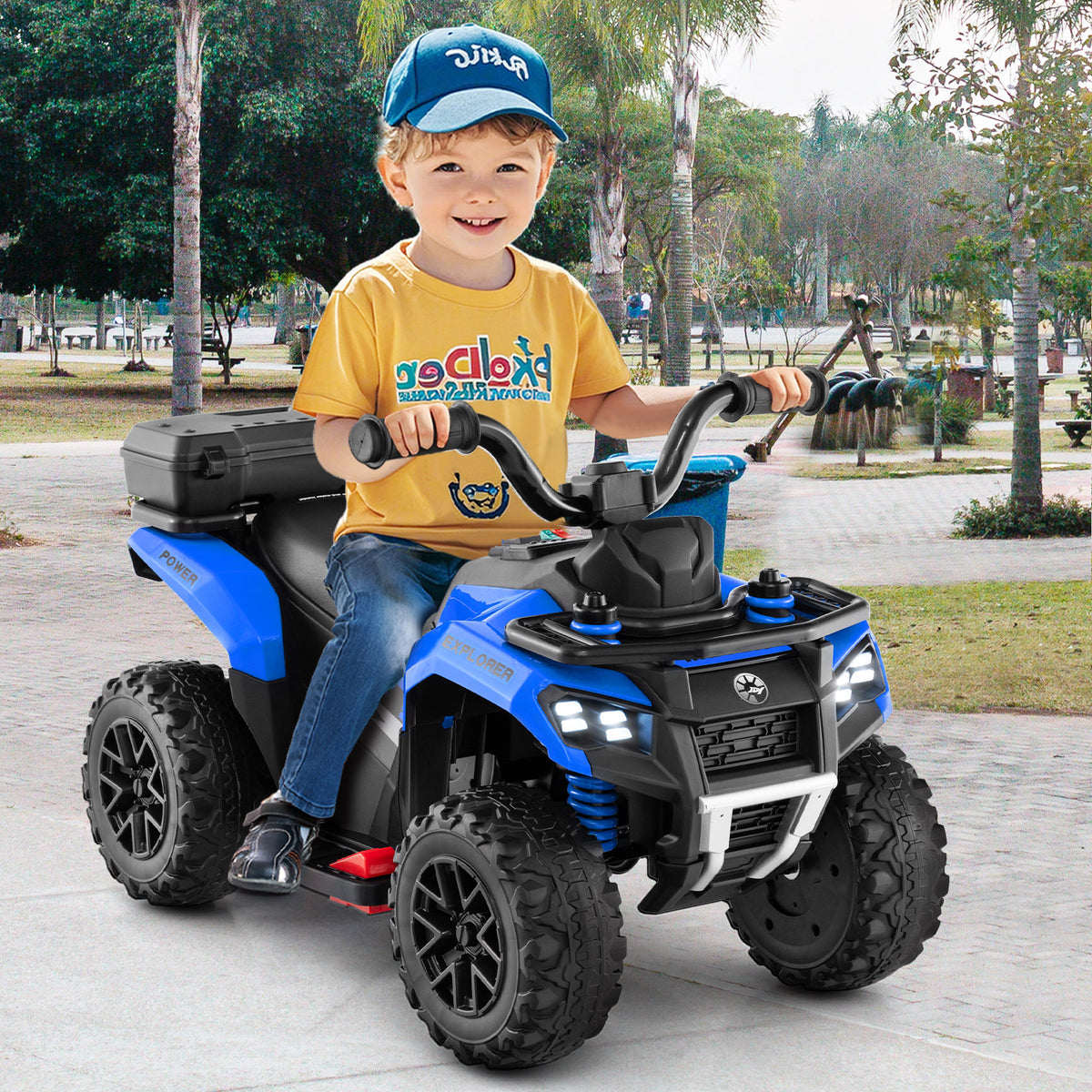 The kids electric quad bike being ridden by a young boy in a park setting