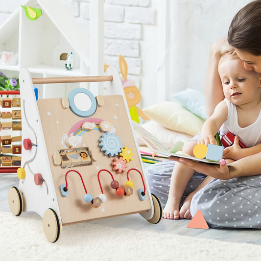The baby walker placed on a rug next to a mother and child playing with wooden shapes