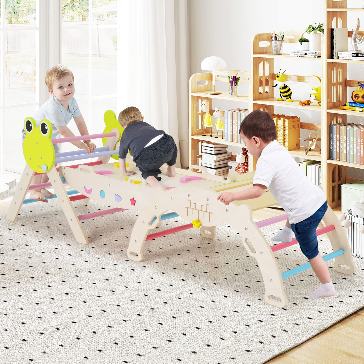 Three children playing on the wooden climbing frames in a bright nursery room with bookshelves