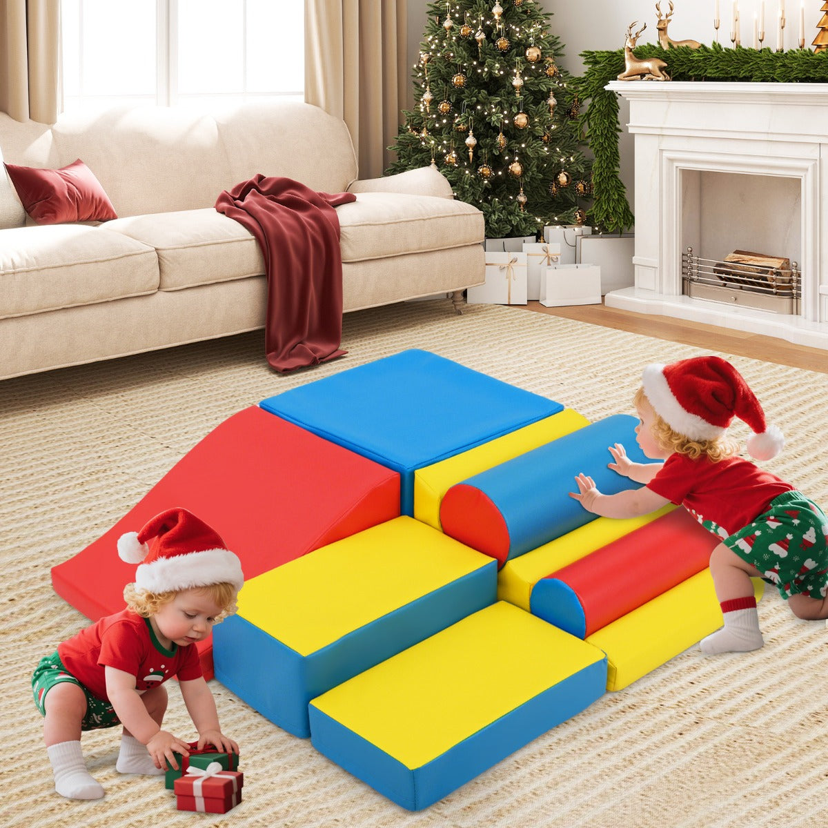 Two babies playing on the soft play sets in a festive living room