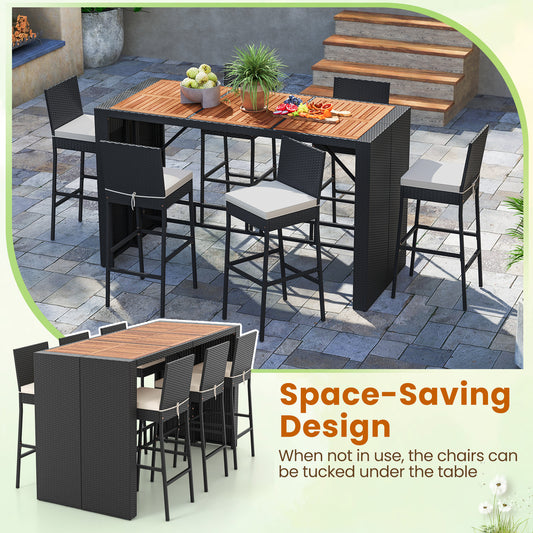The patio furniture set arranged on a stone patio with chairs tucked under the table