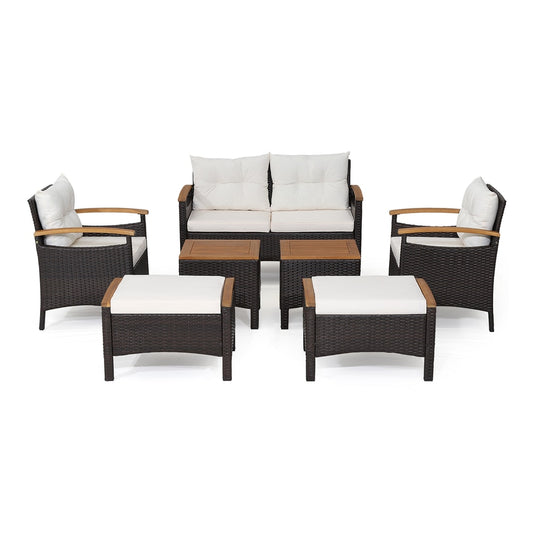 7 Piece Patio Rattan Sofa Set Outdoor with cushions and ottomans arranged on a patio