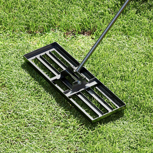 The lawn leveling rake being used on a grassy area