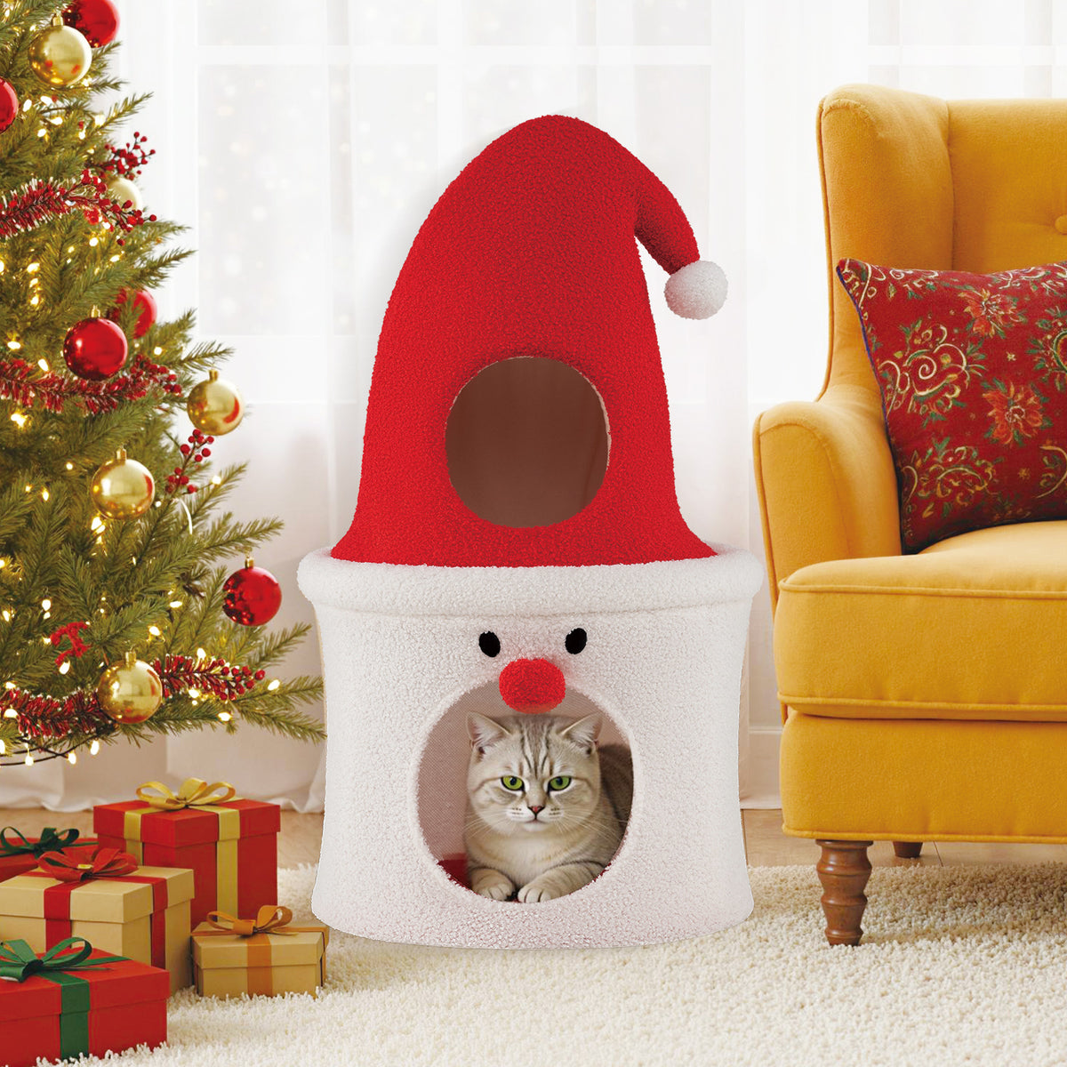 The cat condo is placed in a festive room next to a Christmas tree and presents