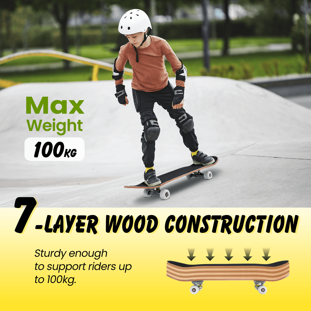 A child wearing protective gear on the black cruiser skateboard at a skatepark