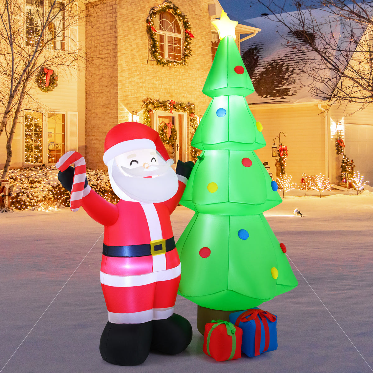 The Christmas inflatable decoration set up outside a house at night, with Santa and a tree illuminated against the dark sky