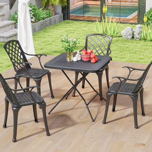 The patio table set up with four chairs around it on a patio