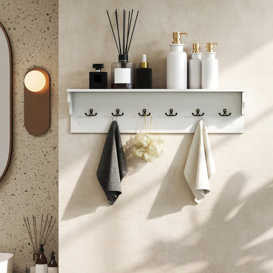 The white wooden coat rack with shelf is shown in a bathroom setting, holding two towels