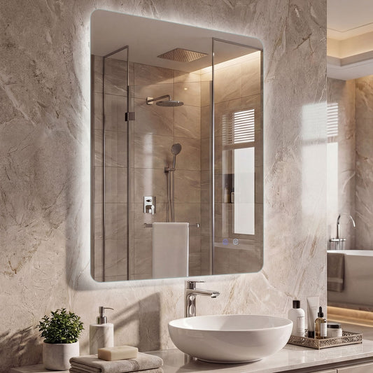 The lighted mirror above a sink in a stylish bathroom with toiletries