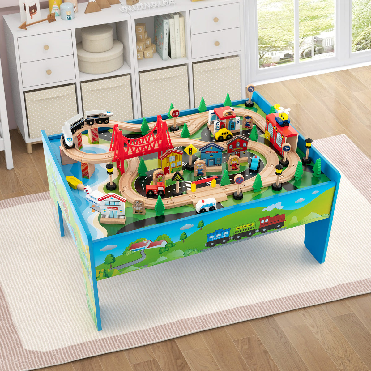 The wooden activity playset with a train set, shown in a child's room