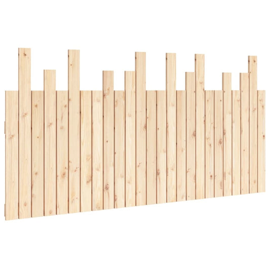 The wooden headboard featuring vertical slats of varying heights against a plain background