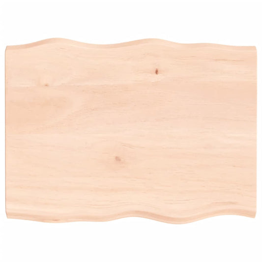 Untreated solid wood live edge table top with a wavy edge