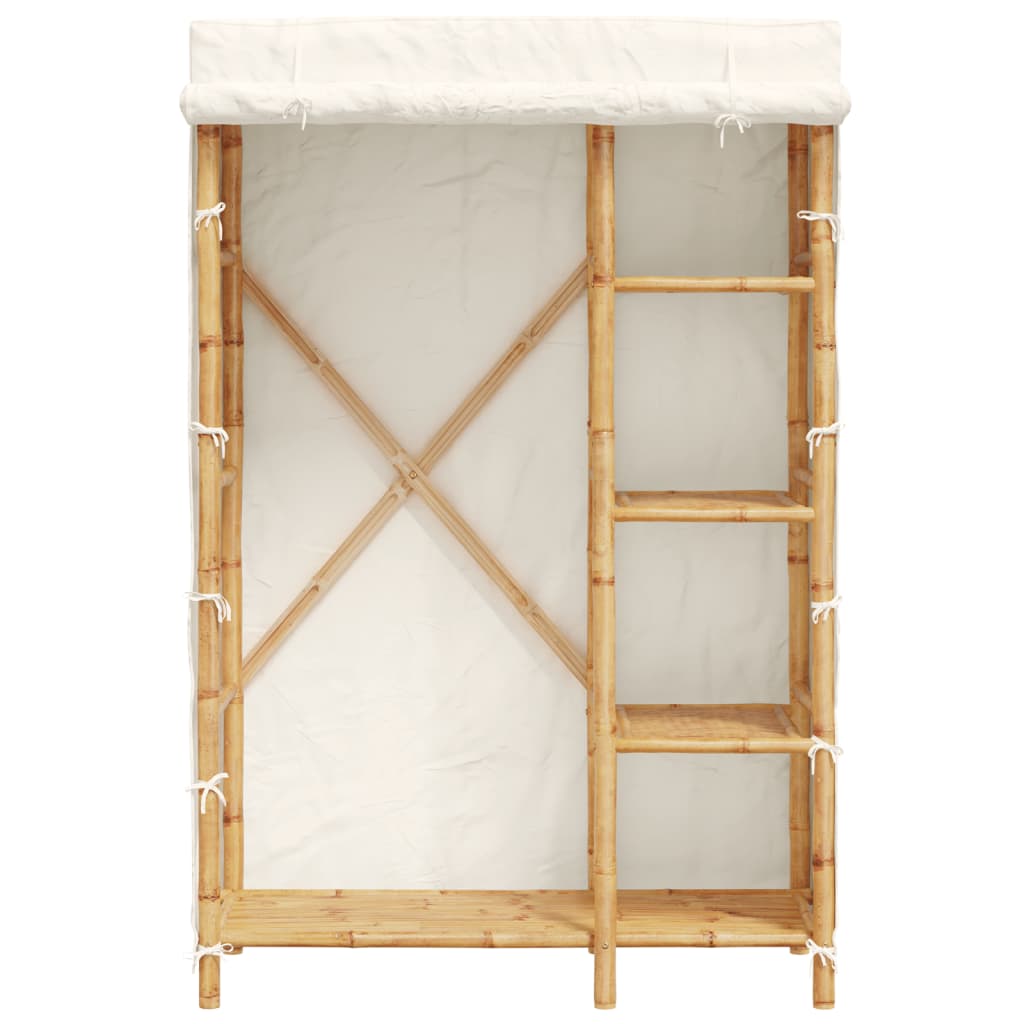 The bamboo wardrobe with shelves and a hanging rail visible behind the open cover