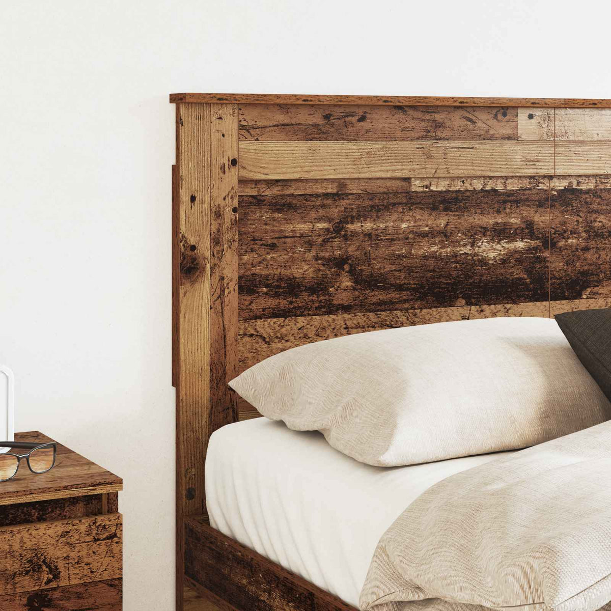 A close-up of the headboard showing the textured wood grain and bed linen