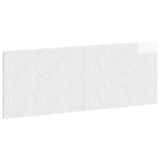 Close-up of the embossed leaf pattern on the white headboard