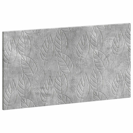 Close up of the textured leaf pattern on the concrete grey headboard