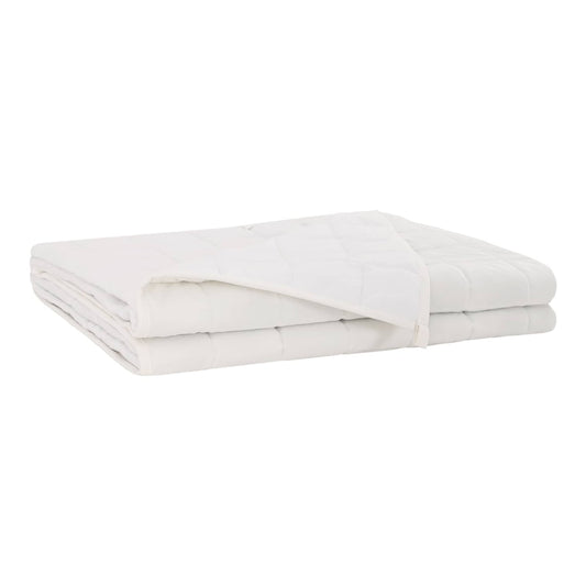 The white weighted blanket folded neatly on a flat surface