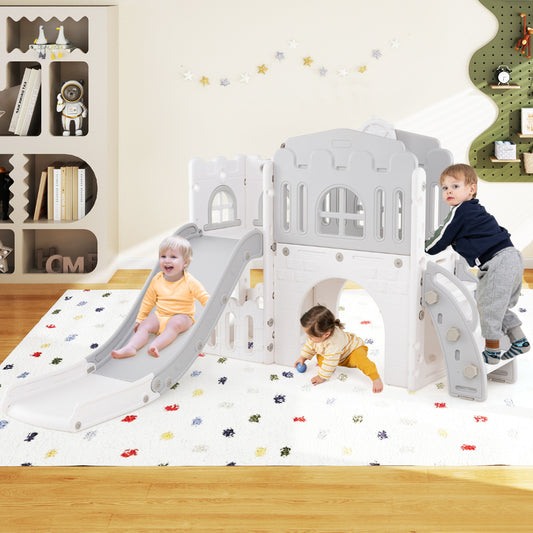 The kids slide and climber playset is set up indoors on a rug with two toddlers playing on it