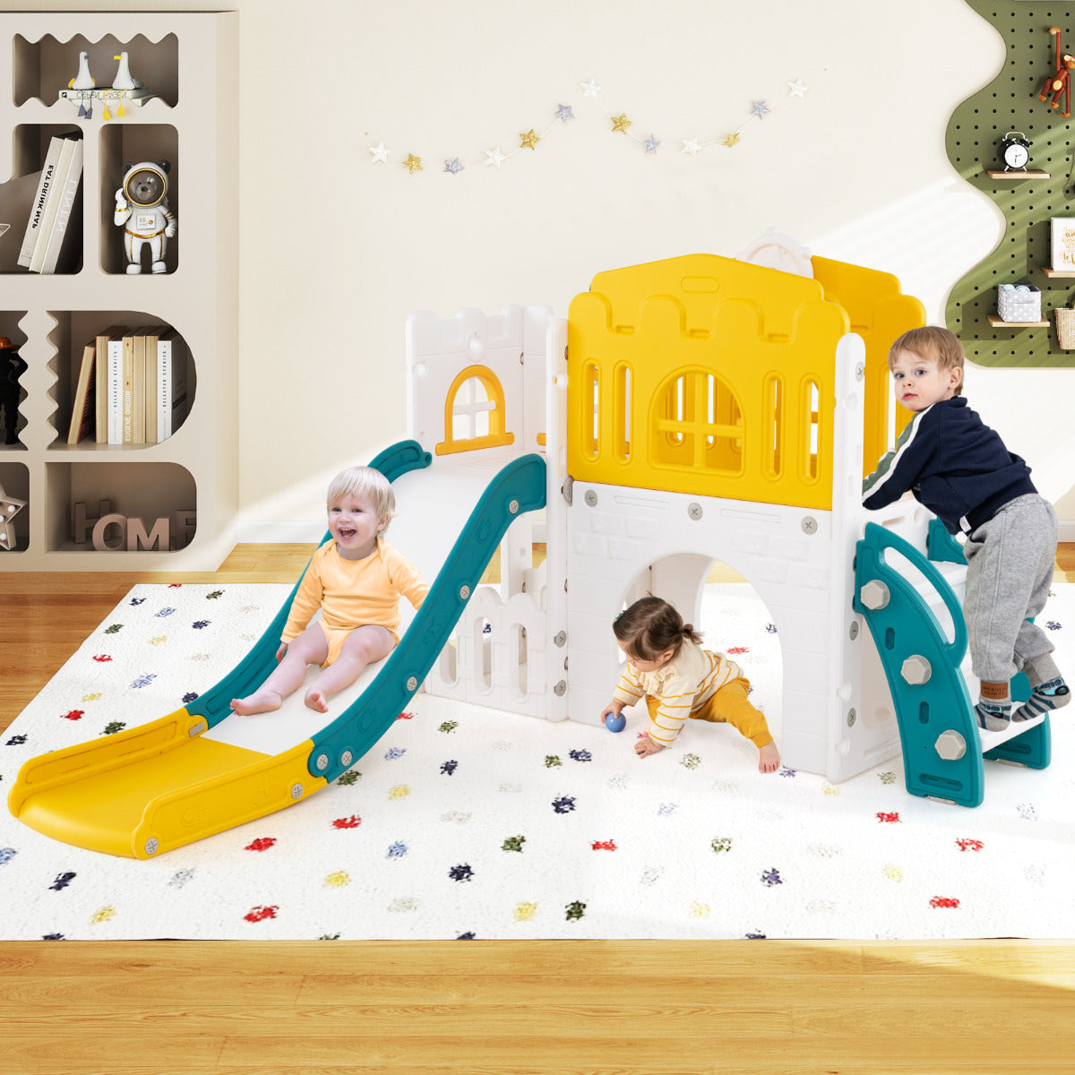 The kids slide and climber playset is shown indoors on a rug with two toddlers playing on it
