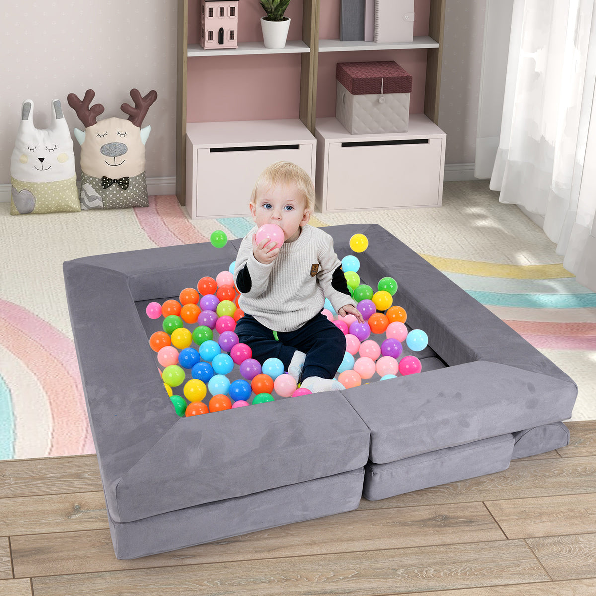 Baby in a ball pit made from the modular kids play couch