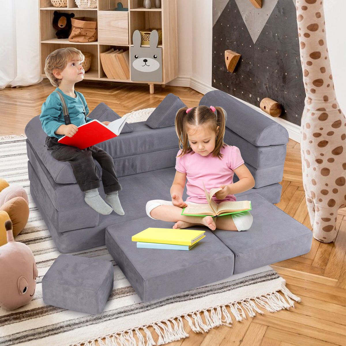 Two children reading books on the modular kids play couch in a room