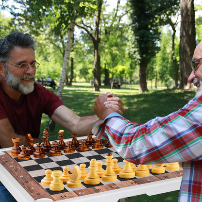 The folding chess table being used by two people playing chess outdoors