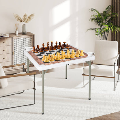 The folding chess table set up in a living room with chess pieces