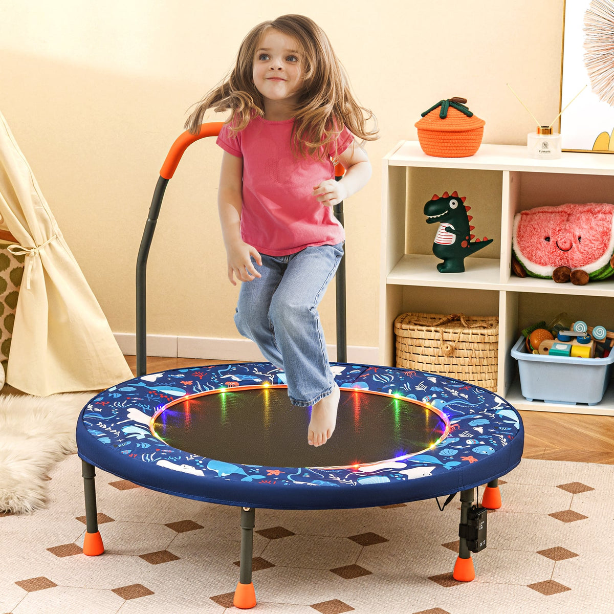 The mini trampoline in a child's bedroom with a girl jumping and colourful LED lights
