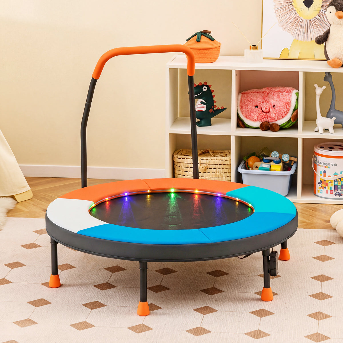 The kids trampoline standing in a playroom next to a white storage unit with toys
