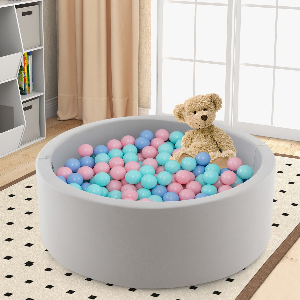 The soft play set placed on a patterned rug with a teddy bear sitting inside