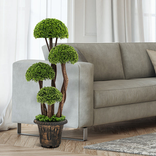 The artificial cypress tree with pot placed in a modern living room next to a sofa