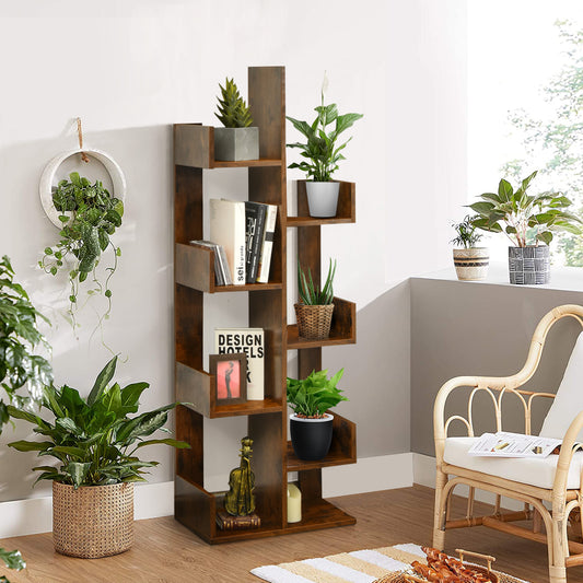 The tree-shaped bookcase is styled with plants and books in a bright living room setting