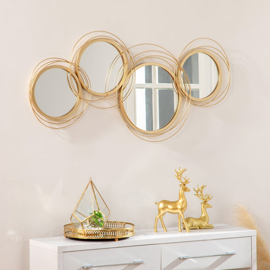 The decorative mirror hanging on a light wall above a white sideboard with gold ornaments
