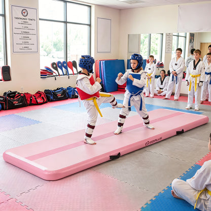 The tumbling mat used by two children in martial arts gear inside a training studio