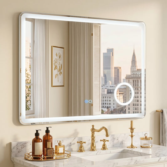 The bathroom mirror with anti-fog and magnification is lit and reflects a city view above a sink