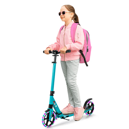 A smiling girl with a pink backpack rides the turquoise scooter