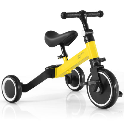 Yellow convertible balance bike with black wheels and pedals, shown from the side
