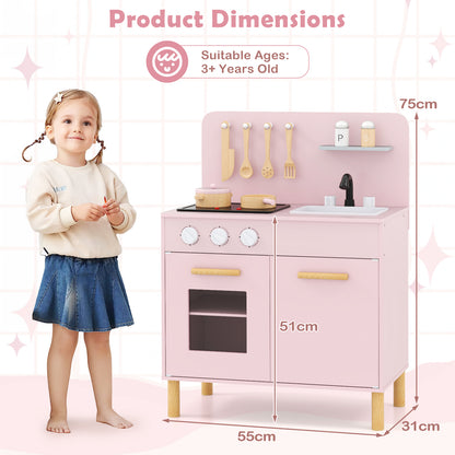 The play kitchen set next to a young girl showing the height and width dimensions