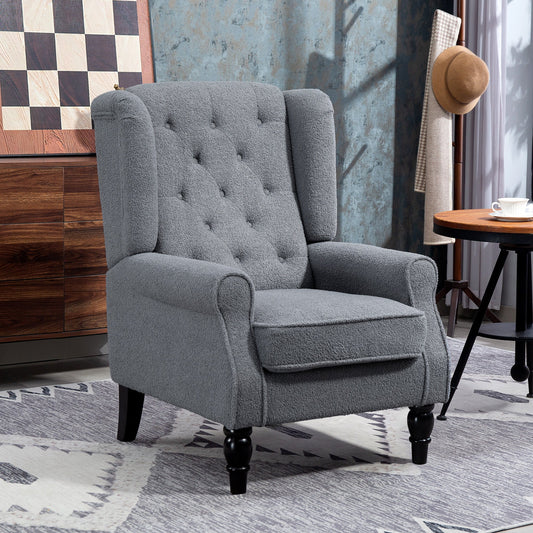 The grey accent chair placed in a living room setting next to a wooden cabinet and small table