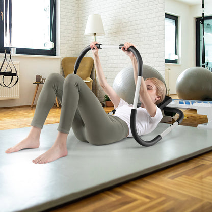 Woman using the abdominal crunch fitness trainer on a yoga mat