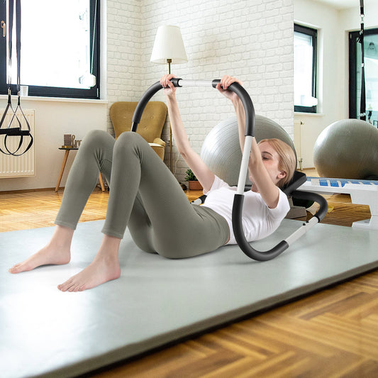 Woman using the abdominal crunch fitness trainer on a yoga mat