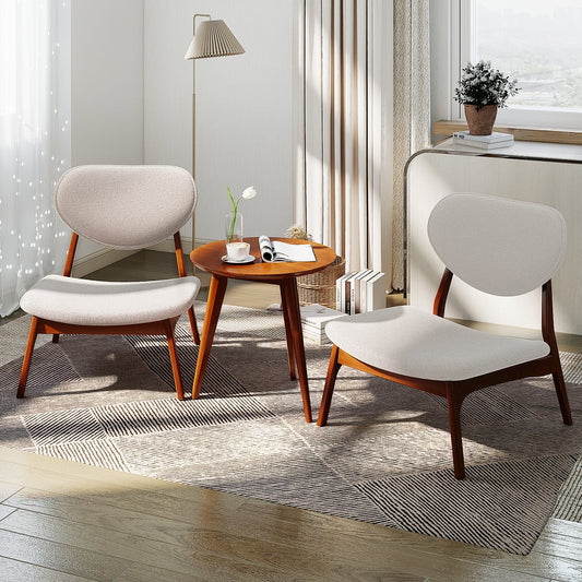Two beige accent chairs and a side table in a modern living room setting