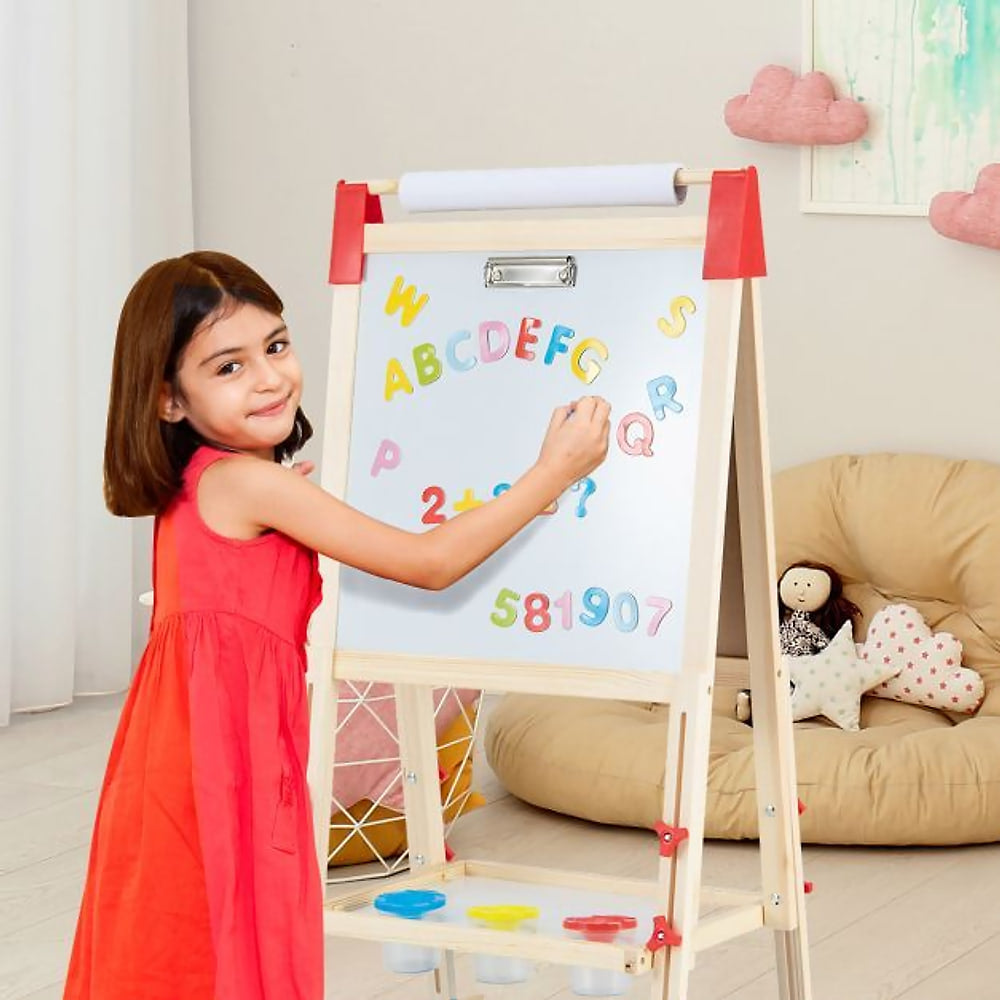 The art easel being used by a girl placing magnetic letters on the whiteboard side