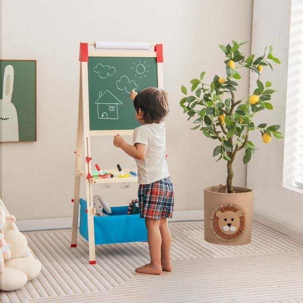 The art easel in a room with a child drawing on the green chalkboard surface