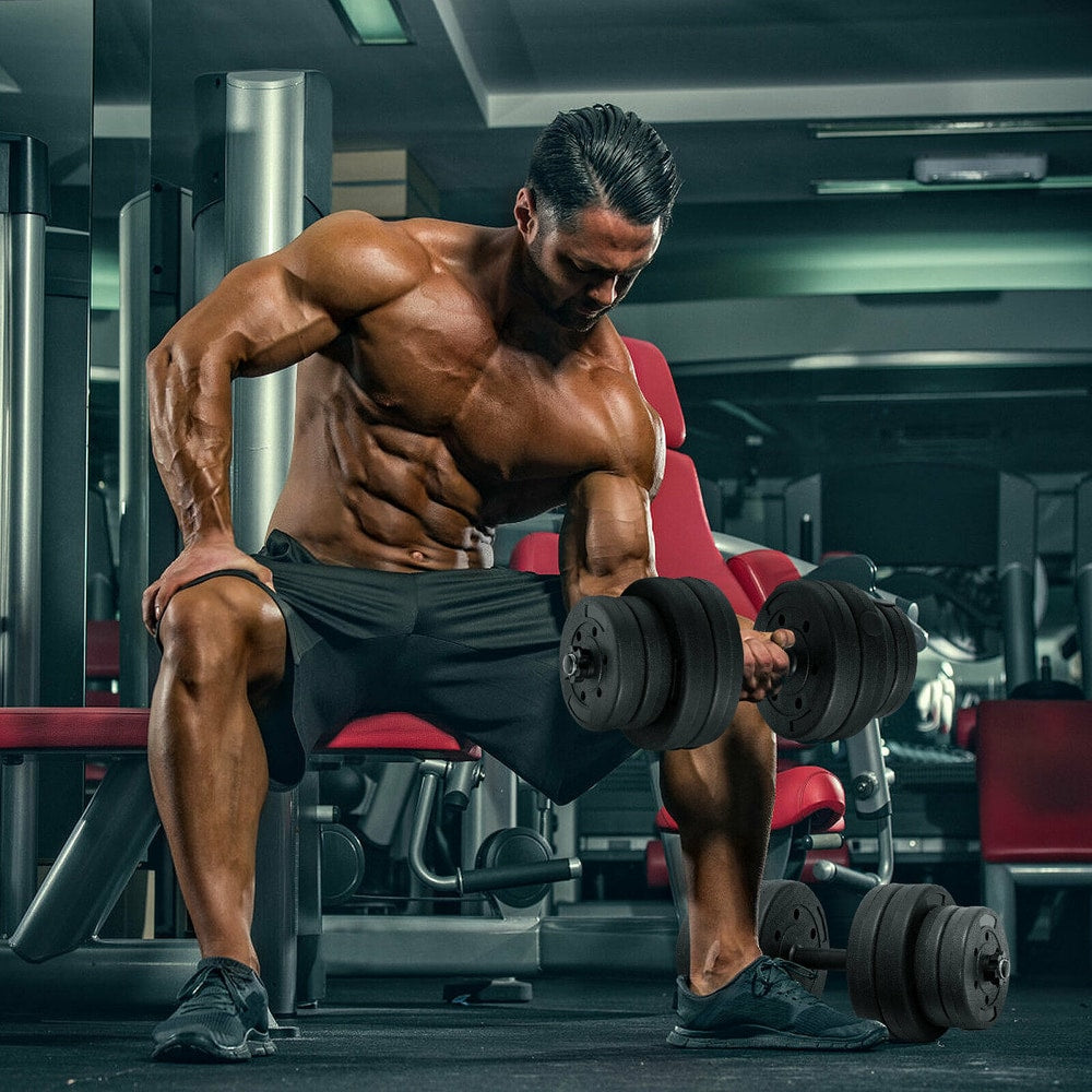 Man using the adjustable weight dumbbell set for bicep curls in a gym